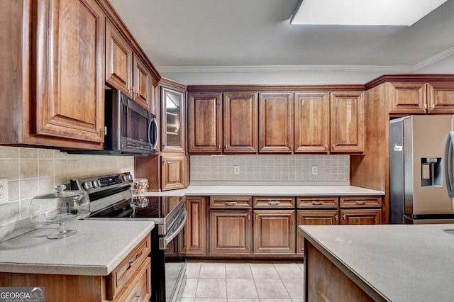 kitchen with brown cabinets, light countertops, backsplash, and stainless steel appliances