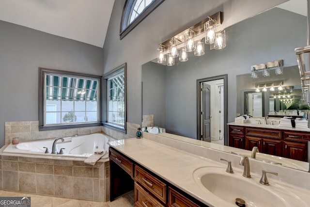 full bathroom featuring a wealth of natural light, tile patterned floors, vanity, and a garden tub