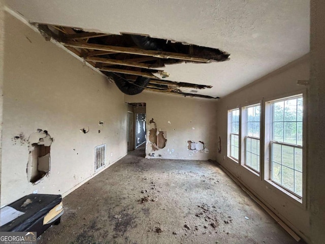 unfurnished living room featuring visible vents