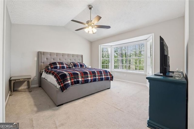 carpeted bedroom with baseboards, a textured ceiling, ceiling fan, and lofted ceiling