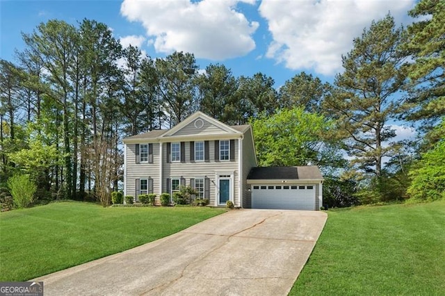 view of front facade with driveway, an attached garage, and a front lawn