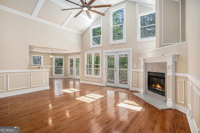 116 Little Ln, Lula, GA 30554 - unfurnished living room featuring a fireplace, french doors, a ceiling fan, hardwood / wood-style floors, and a decorative wall