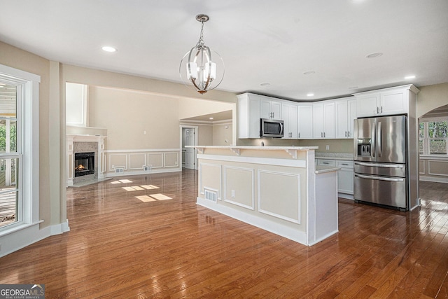 116 Little Ln, Lula, GA 30554 - kitchen with plenty of natural light, an inviting chandelier, dark wood-style flooring, light countertops, and appliances with stainless steel finishes