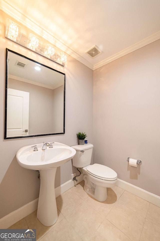 2626 Peachtree Rd NW Unit 412, Atlanta, GA 30305 - bathroom featuring crown molding, visible vents, toilet, and baseboards