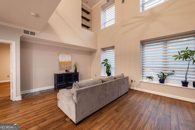 2626 Peachtree Rd NW Unit 412, Atlanta, GA 30305 - living room featuring visible vents, baseboards, crown molding, and dark wood-style floors