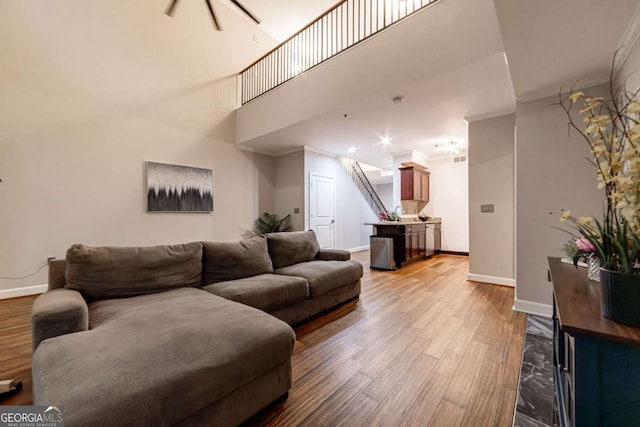 2626 Peachtree Rd NW Unit 412, Atlanta, GA 30305 - living room with crown molding, baseboards, a towering ceiling, and wood finished floors