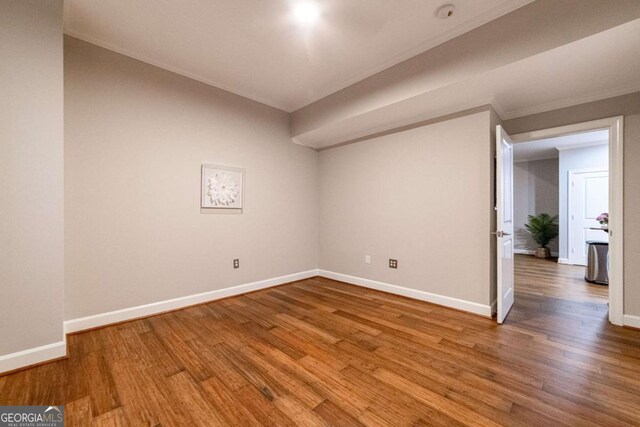 2626 Peachtree Rd NW Unit 412, Atlanta, GA 30305 - spare room with baseboards, ornamental molding, and wood finished floors