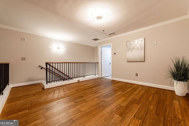 2626 Peachtree Rd NW Unit 412, Atlanta, GA 30305 - empty room with crown molding, visible vents, baseboards, and wood finished floors