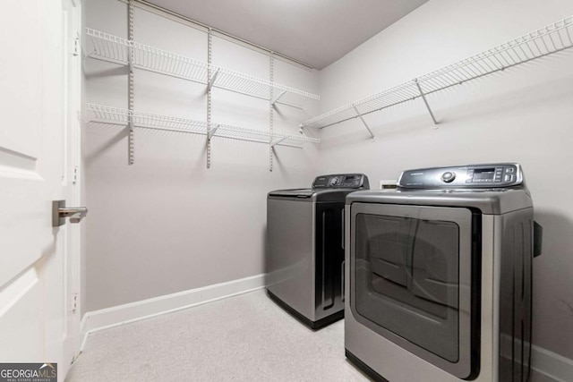 2626 Peachtree Rd NW Unit 412, Atlanta, GA 30305 - washroom featuring washer and dryer, laundry area, and baseboards