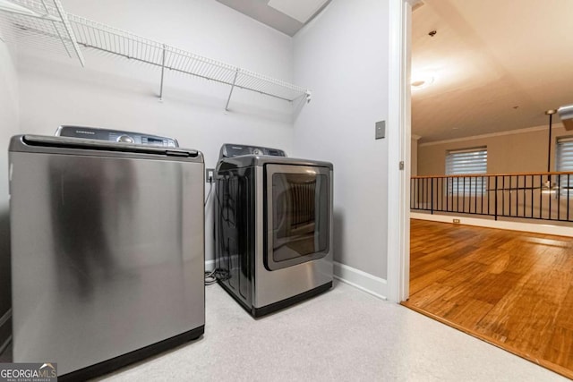 2626 Peachtree Rd NW Unit 412, Atlanta, GA 30305 - clothes washing area featuring baseboards, washer and dryer, and laundry area
