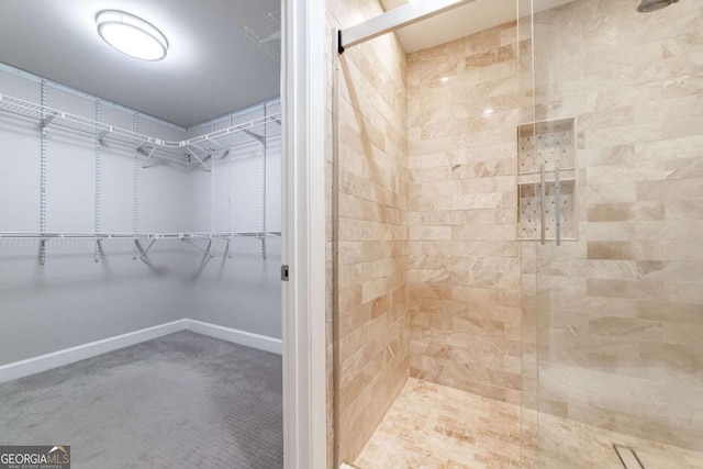 2626 Peachtree Rd NW Unit 412, Atlanta, GA 30305 - full bath with a tile shower, baseboards, and a walk in closet