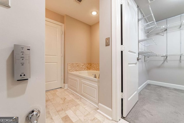 2626 Peachtree Rd NW Unit 412, Atlanta, GA 30305 - bathroom with visible vents, a bath, and baseboards