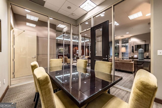 2626 Peachtree Rd NW Unit 412, Atlanta, GA 30305 - dining room featuring carpet flooring, baseboards, and a drop ceiling
