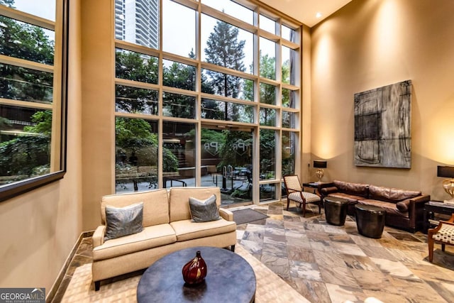 2626 Peachtree Rd NW Unit 412, Atlanta, GA 30305 - living area with a towering ceiling, baseboards, and a wall of windows
