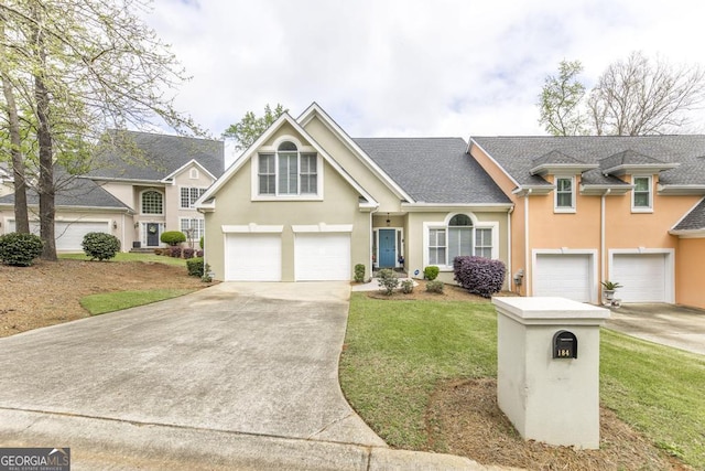 view of front facade featuring concrete driveway, roof with shingles, stucco siding, a front yard, and a garage