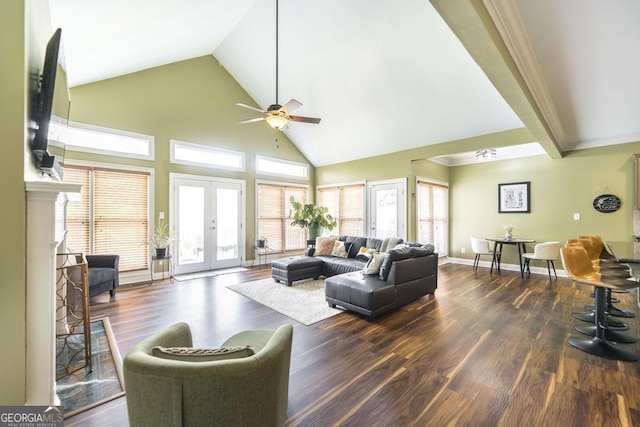 living area featuring high vaulted ceiling, baseboards, wood finished floors, and ceiling fan