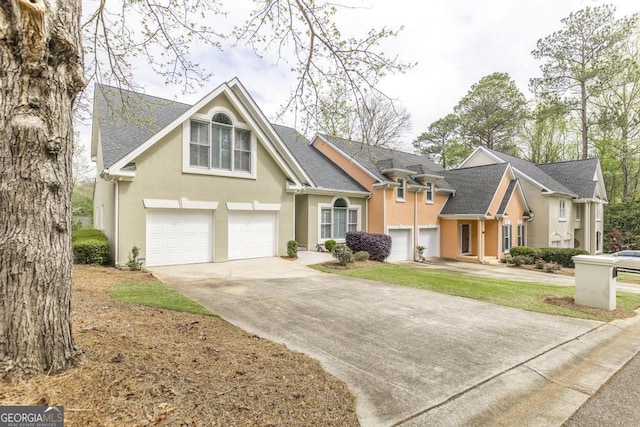 view of front of home with a garage, roof with shingles, stucco siding, and concrete driveway