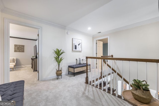 sitting room with crown molding, visible vents, carpet floors, an upstairs landing, and baseboards