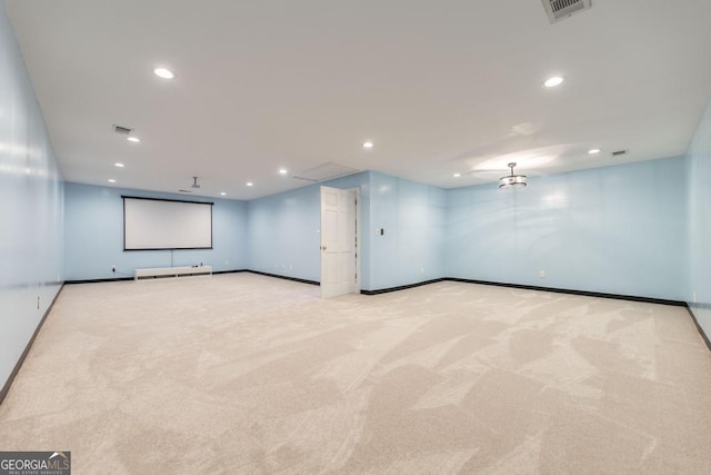 carpeted empty room with visible vents, baseboards, and recessed lighting