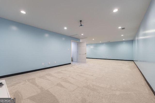 empty room featuring baseboards, light carpet, recessed lighting, attic access, and visible vents