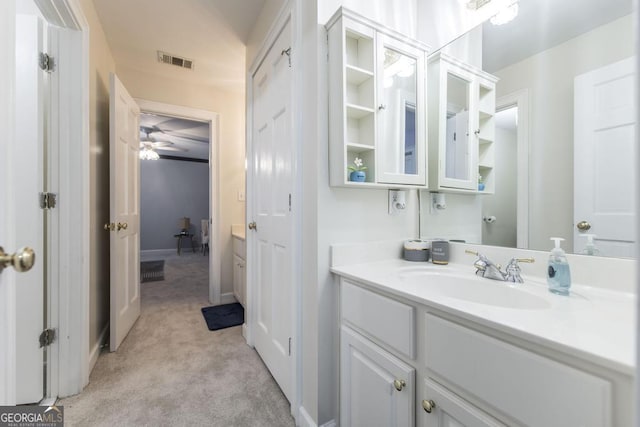 bathroom featuring vanity, visible vents, baseboards, and ceiling fan