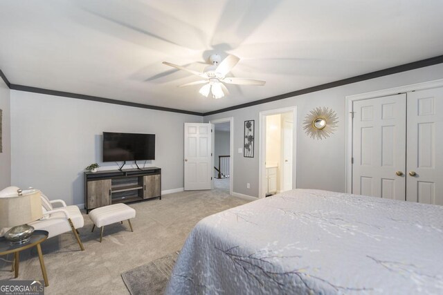 bedroom featuring crown molding, a closet, light colored carpet, a ceiling fan, and baseboards