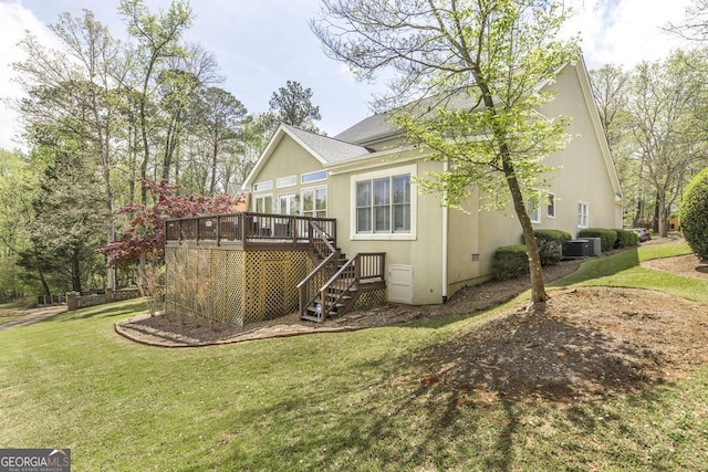 back of property featuring roof with shingles, central air condition unit, stairs, a wooden deck, and a yard