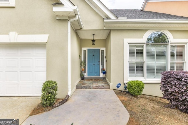 property entrance with roof with shingles and stucco siding