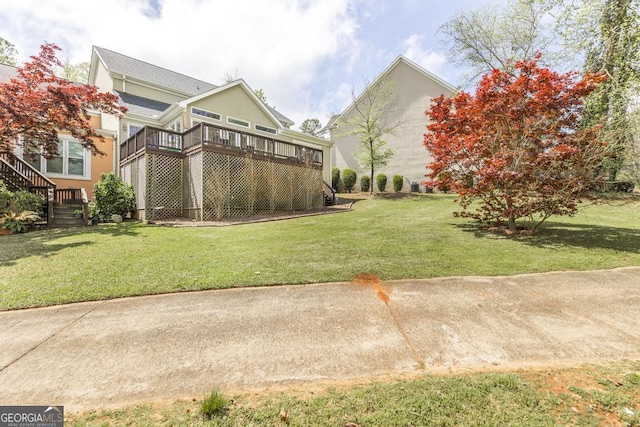 view of yard with a deck and stairway