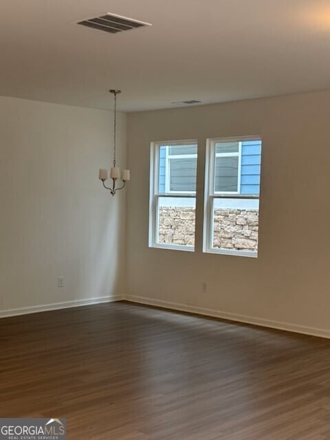 182 Parkwood Dr Unit 32, Dawsonville, GA 30534 - spare room featuring baseboards, dark wood-style flooring, visible vents, and an inviting chandelier