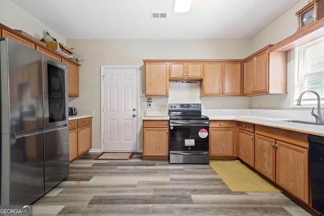 kitchen with a sink, visible vents, light countertops, and appliances with stainless steel finishes