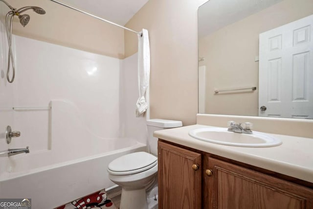 bathroom featuring toilet, bathing tub / shower combination, and vanity
