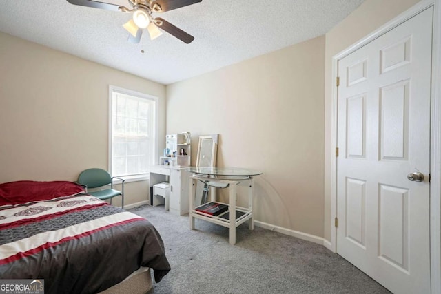 bedroom featuring carpet floors, baseboards, and a textured ceiling