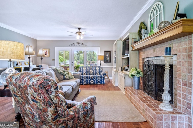 126 N Valhalla Ct, Cordele, GA 31015 - living room featuring a fireplace, a ceiling fan, ornamental molding, a textured ceiling, and wood finished floors