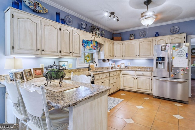 126 N Valhalla Ct, Cordele, GA 31015 - kitchen featuring stainless steel refrigerator with ice dispenser, a sink, a peninsula, light stone counters, and light tile patterned floors