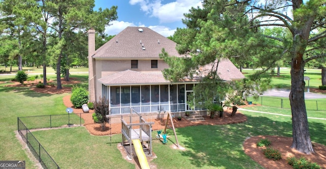 126 N Valhalla Ct, Cordele, GA 31015 - rear view of house featuring a sunroom, roof with shingles, and a chimney