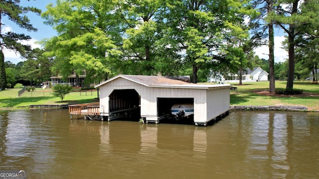 126 N Valhalla Ct, Cordele, GA 31015 - dock area featuring a water view, a lawn, boat lift, and view of scattered trees