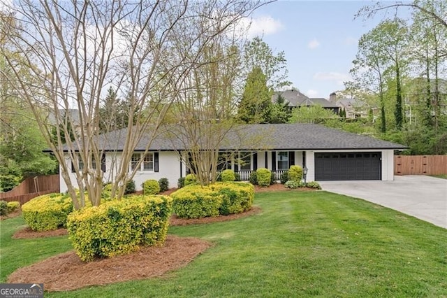 ranch-style house featuring driveway, a garage, fence, and a front lawn