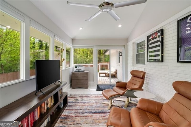 sunroom with tile patterned floors, brick wall, vaulted ceiling, and recessed lighting