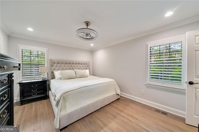 bedroom with light wood-style flooring, ornamental molding, visible vents, recessed lighting, and baseboards