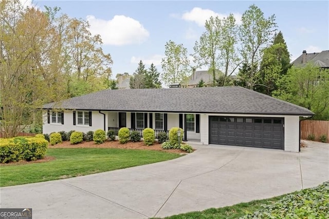 single story home with a garage, a porch, a front lawn, a chimney, and driveway