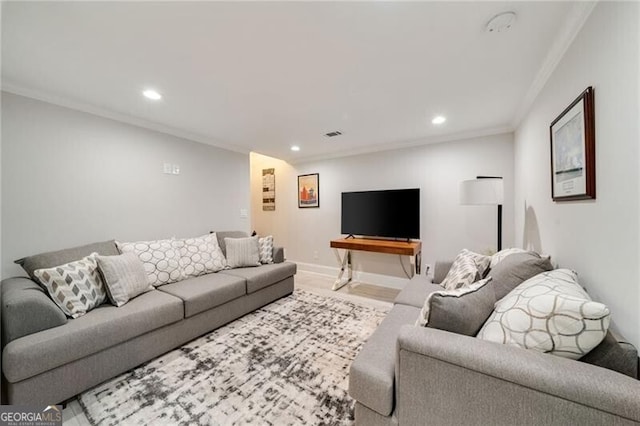 living area with visible vents, baseboards, crown molding, recessed lighting, and wood finished floors