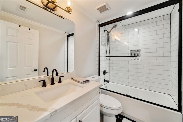bathroom with toilet, crown molding, vanity, and visible vents