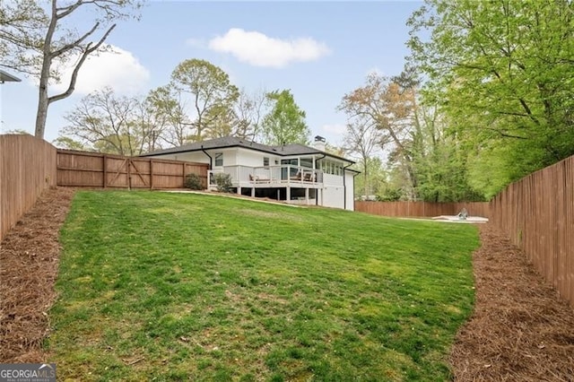 view of yard with a deck and a fenced backyard