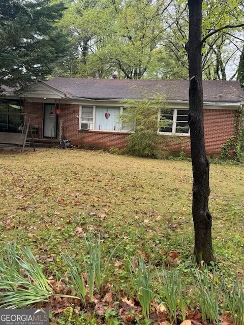 2667 Plantation Dr, Atlanta, GA 30344 - ranch-style home with brick siding, a front yard, and cooling unit