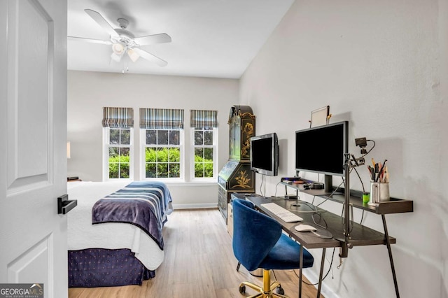 bedroom featuring wood finished floors, baseboards, and a ceiling fan