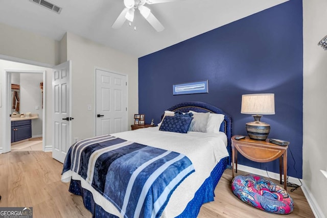 bedroom featuring ceiling fan, visible vents, baseboards, and wood finished floors
