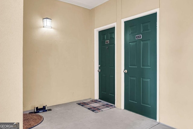 doorway to property featuring stucco siding