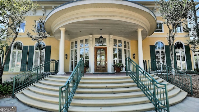 doorway to property featuring stucco siding and french doors