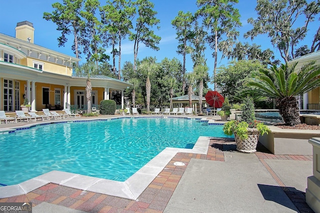 community pool with a patio area
